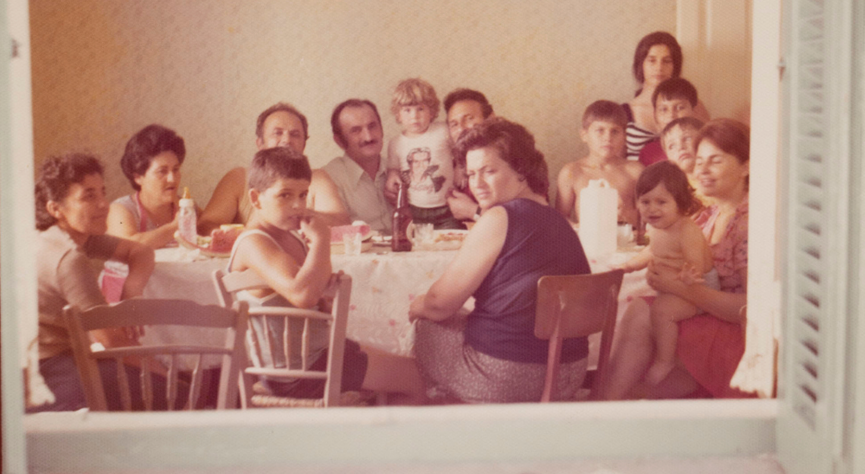 Large family posing for photo at kitchen table