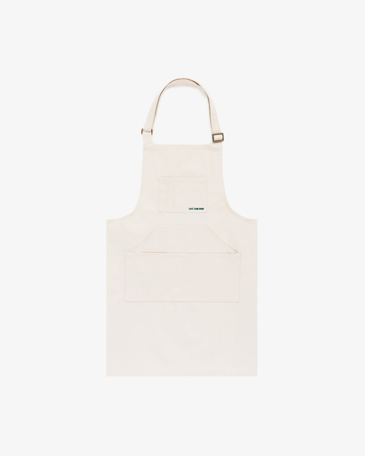 The Café Leon Dore Apron in plain beige features a front pocket and adjustable neck strap, shown on a white background.