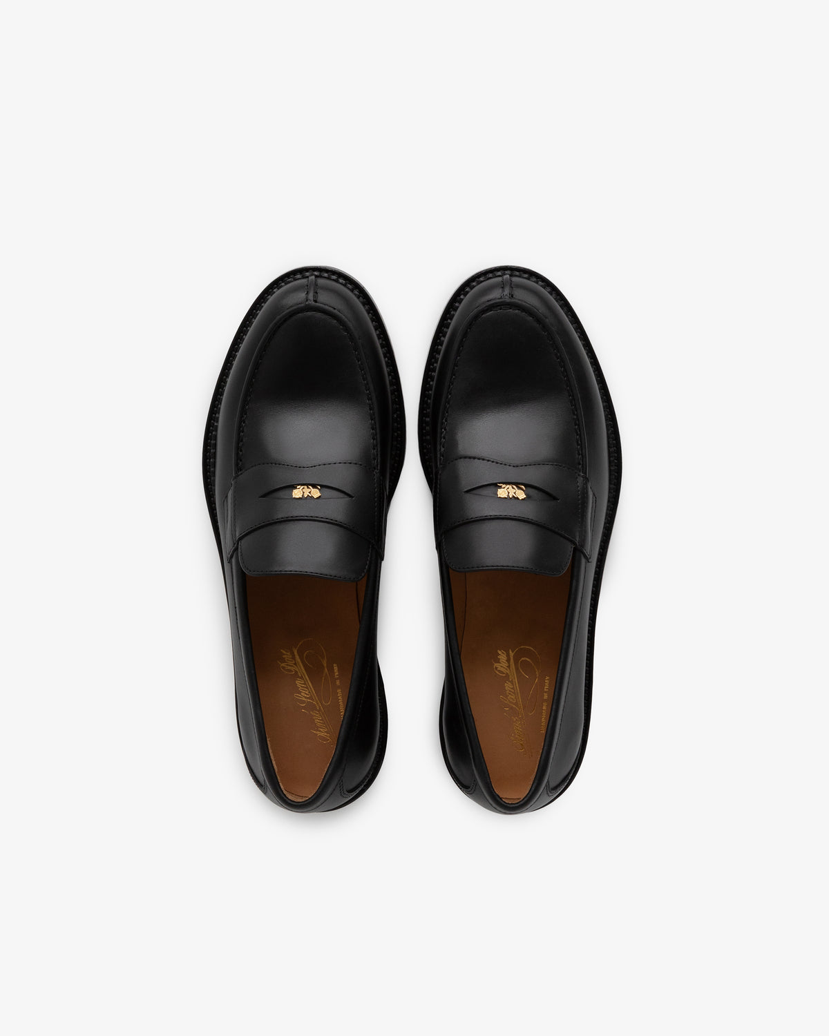Queens Crest Loafer in black leather with gold detailing, shown from above on a white background.