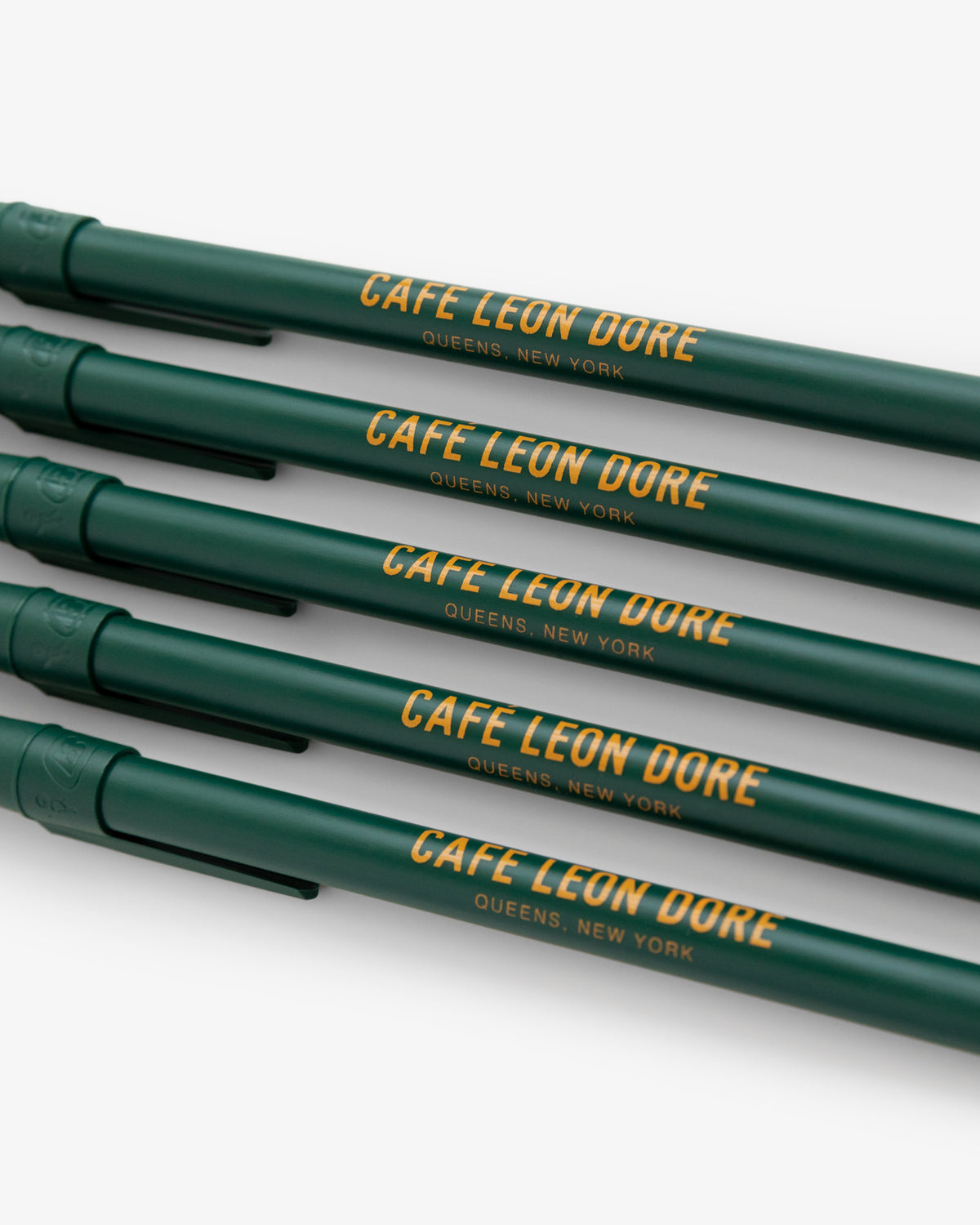Café Leon Dore Ballpoint Pen Pack: Four green pens with QUEENS, NEW YORK in yellow on each barrel.