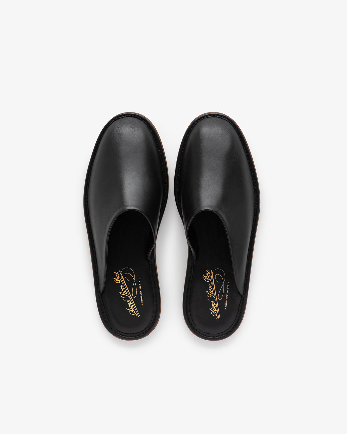 Leather Travel Slipper in black leather, slip-on style, shown from above on a white background.