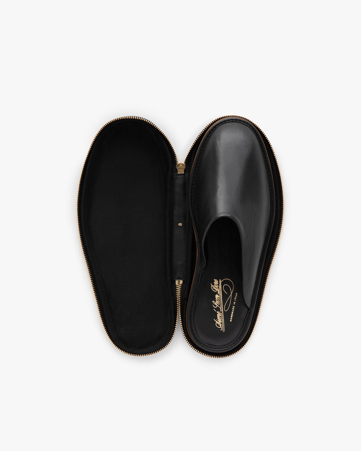 A Leather Travel Slipper in a black oval zippered case, viewed from above on a white background.
