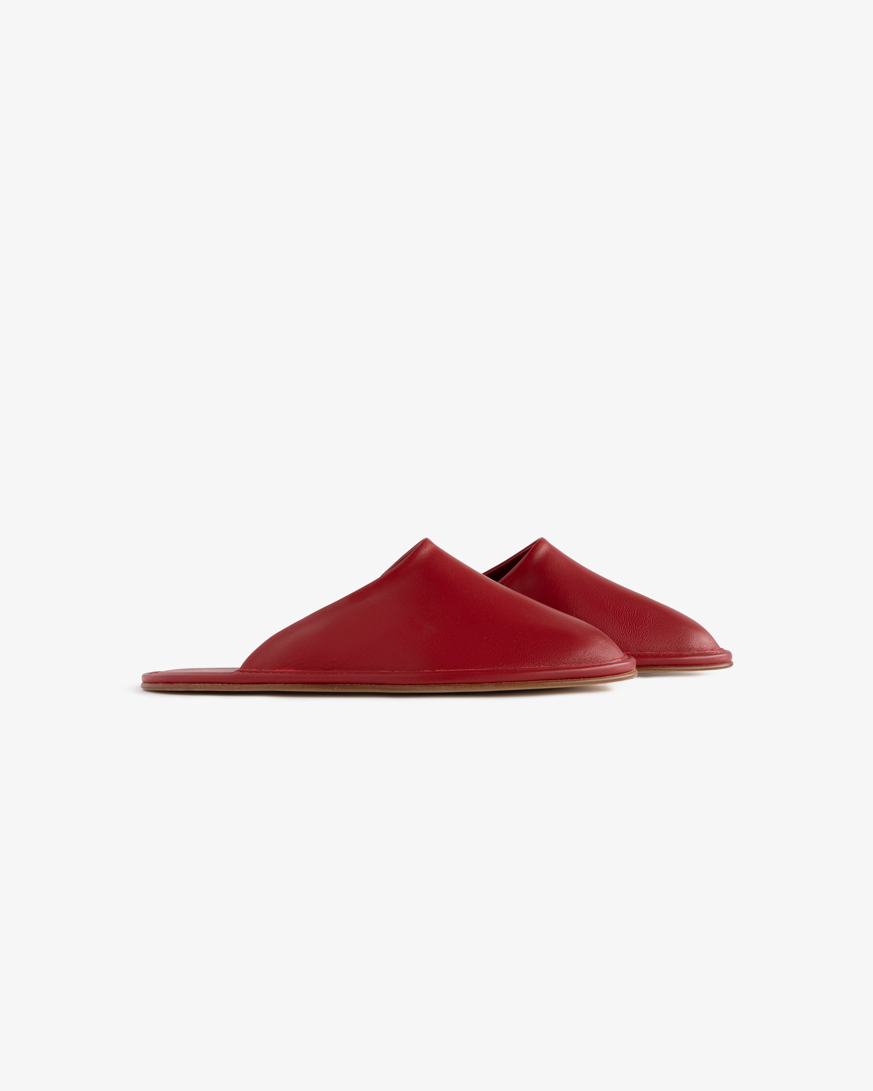 Red Leather Travel Slipper with flat soles, slip-on style, shown against a plain white background.
