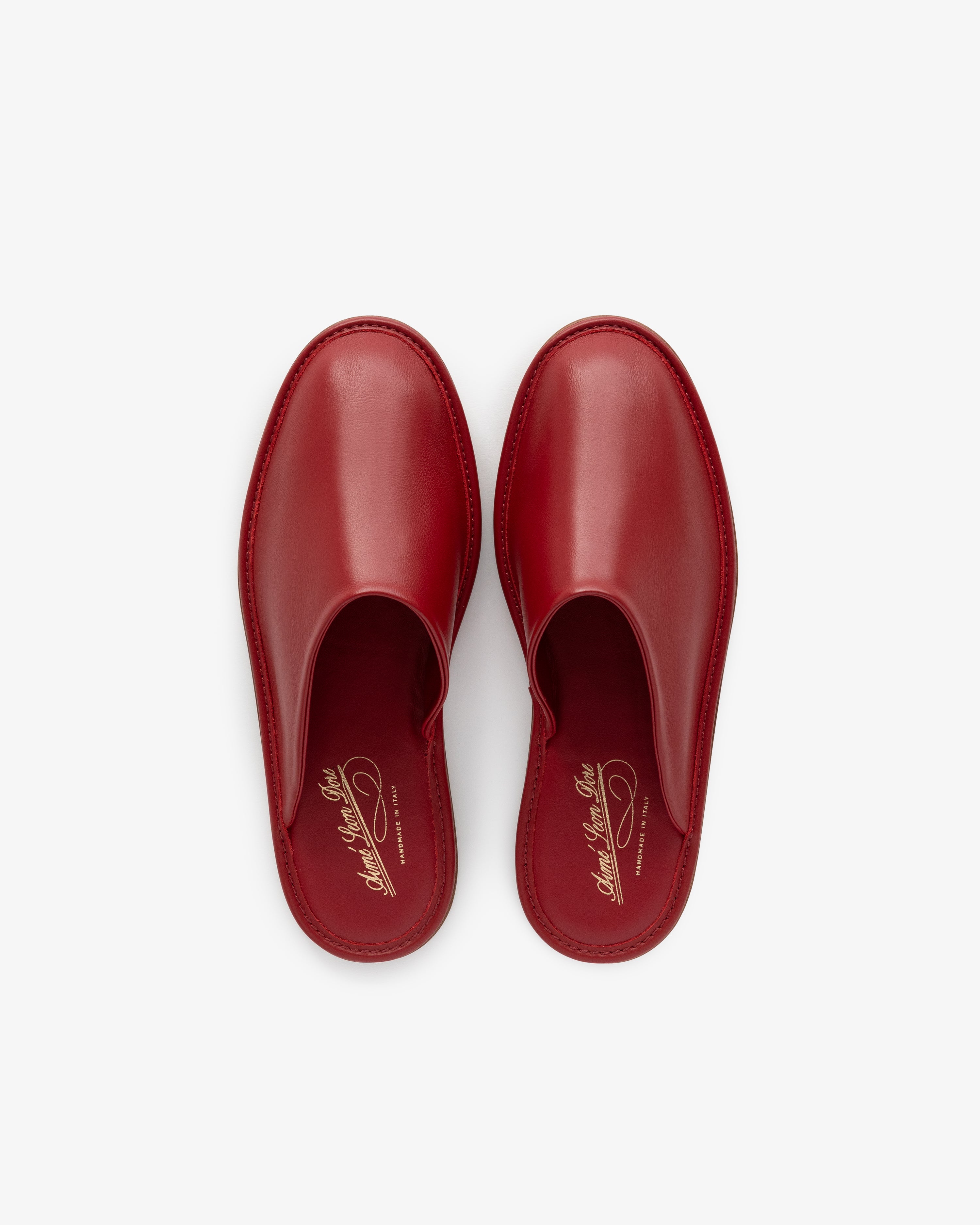 A pair of Leather Travel Slippers in red, viewed from above on a white background.