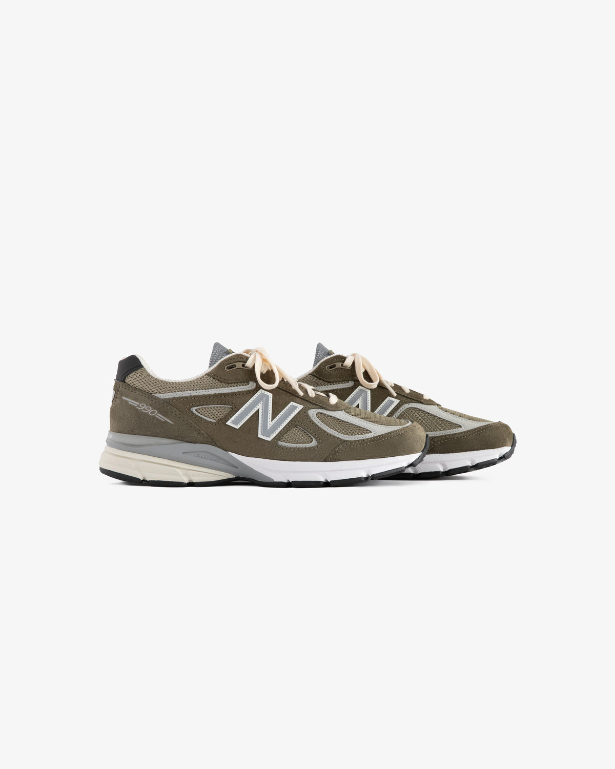 A pair of olive green ALD / New Balance 990v4 sneakers with white soles and beige laces on a white background.