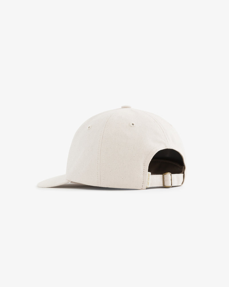 Café Leon Dore Hat in beige, shown from the back with adjustable strap and curved brim on a white background.