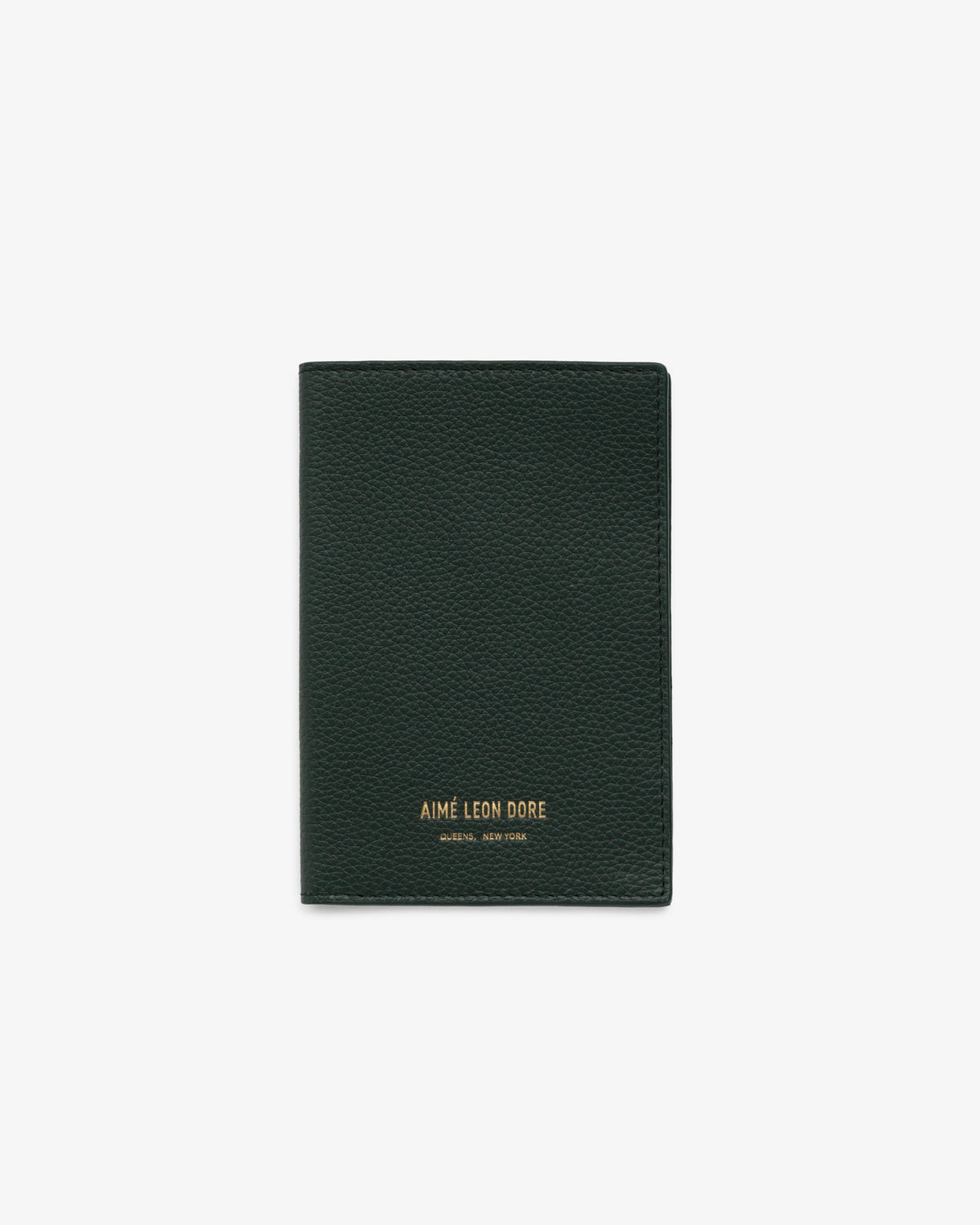 Dark green leather passport holder with gold AIMÉ LEON DORE branding at the bottom center, on a white background.