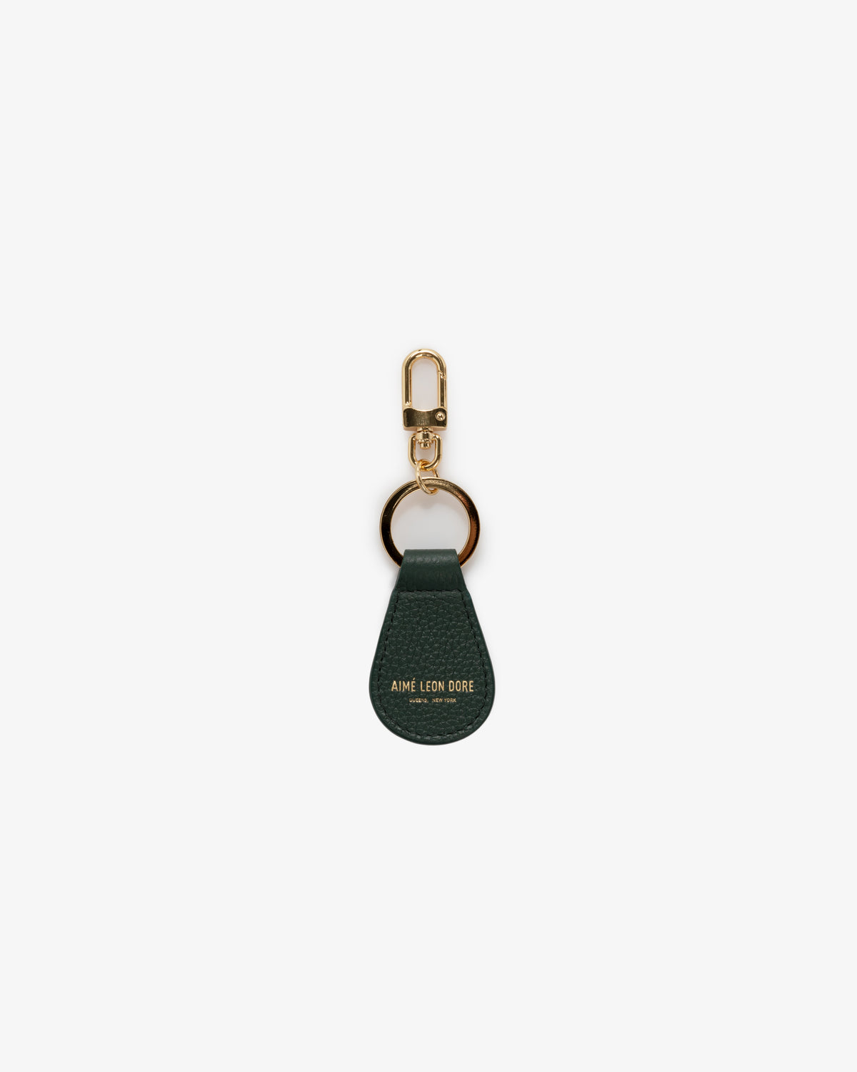 The Leather Key Fob is dark green leather with gold hardware and "Aime Leon Dore" embossed in gold at the bottom.
