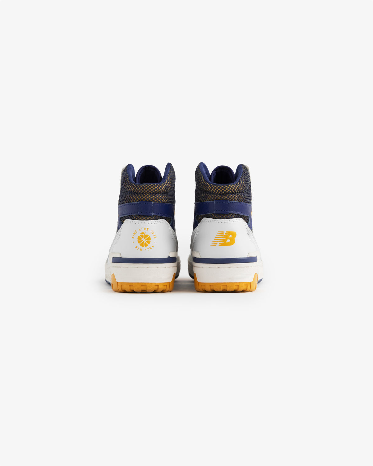 Back view of ALD / New Balance 650R sneakers in white, blue, and yellow with heel logos on a white background.