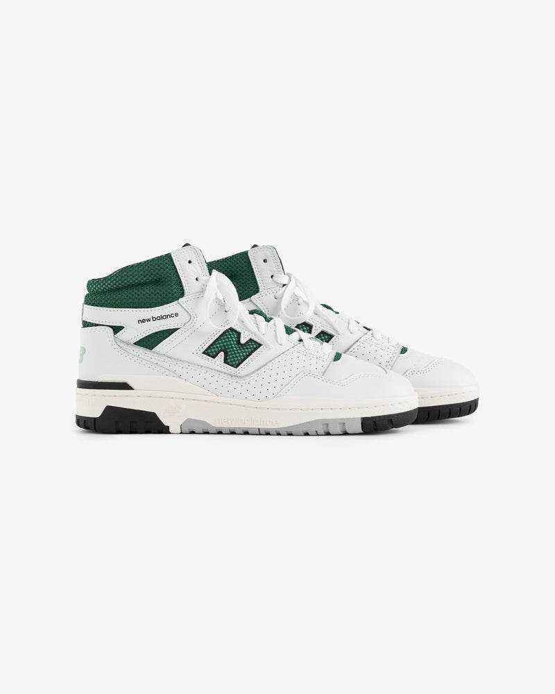 ALD / New Balance 650R high-top sneakers in white and green with black soles, shown from the side.