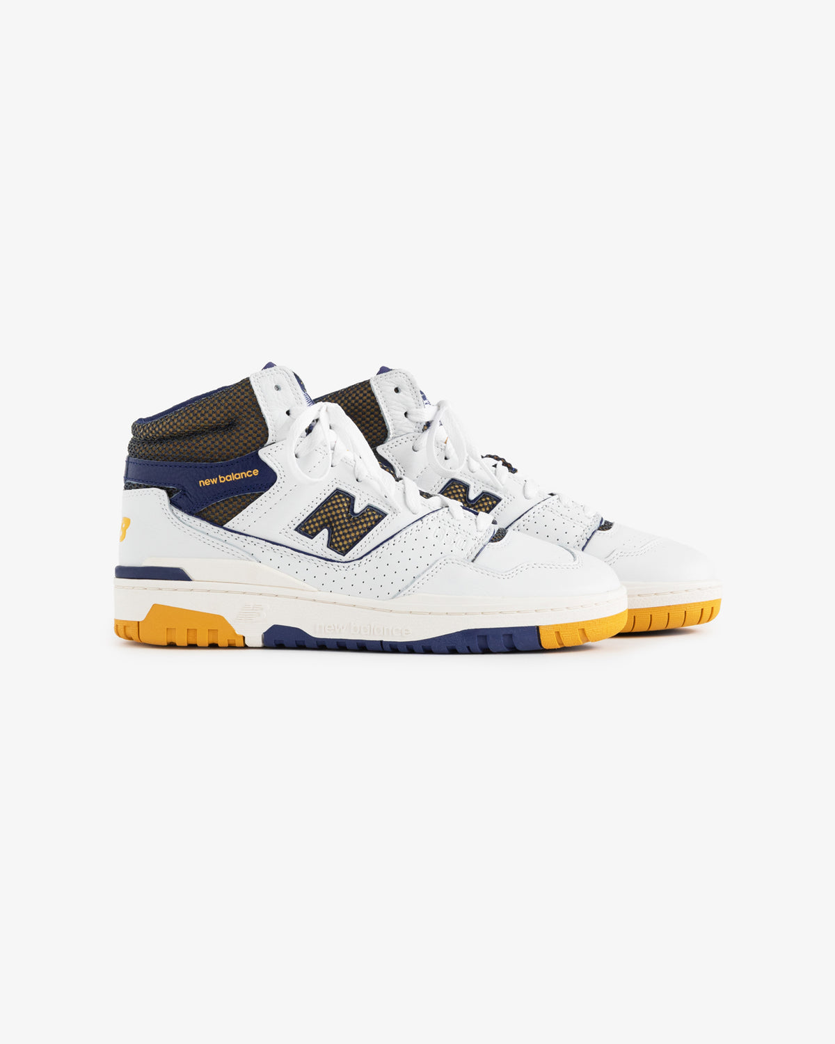 ALD / New Balance 650R sneakers in white and navy with yellow accents, mesh details, and gum soles on white background.