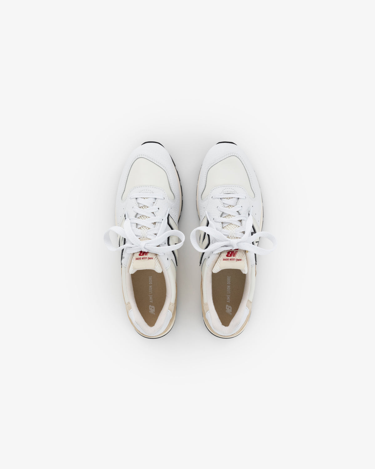 ALD / NB Made in USA 996 white athletic sneakers with laces, viewed from above on a plain white background.