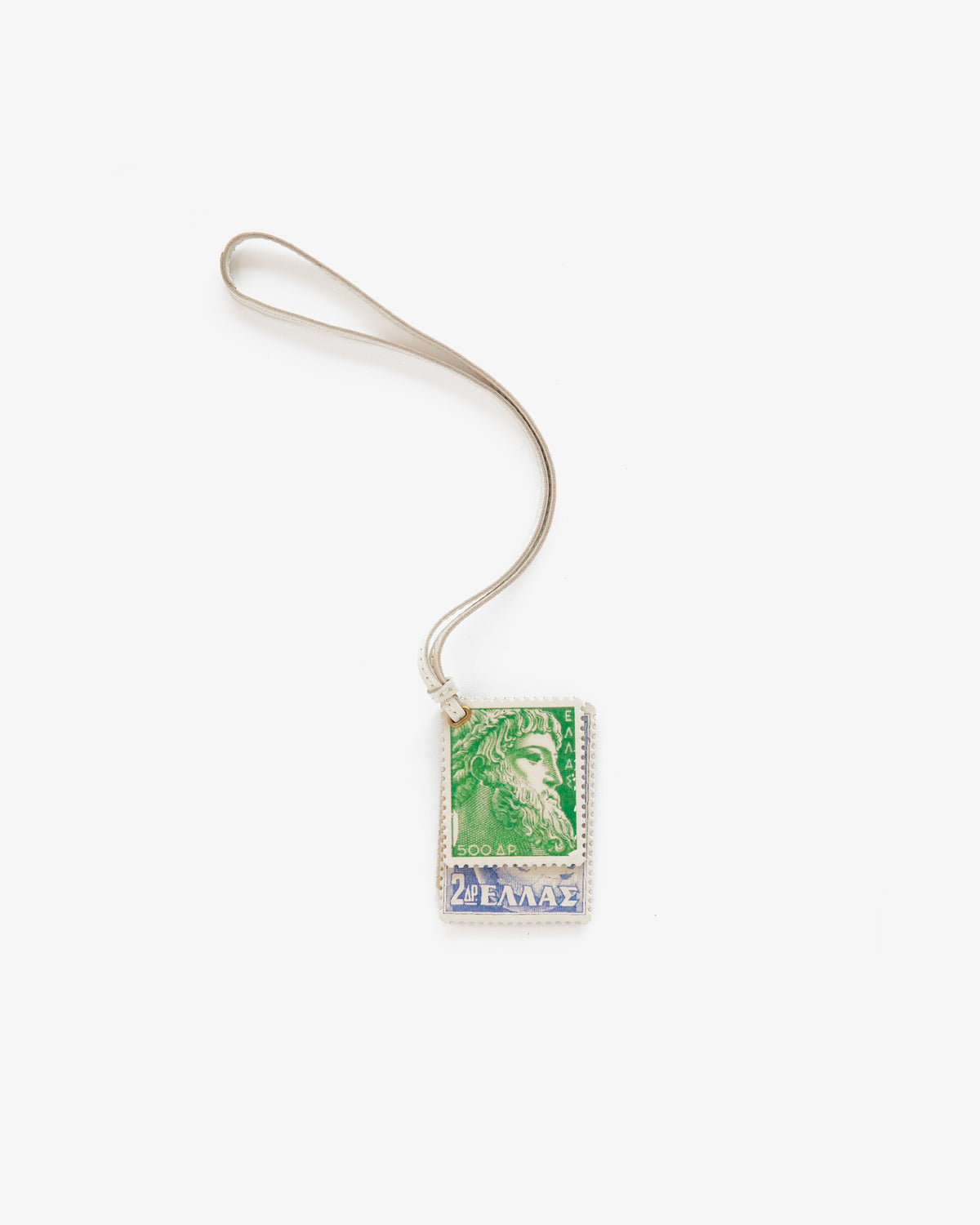 A Leather Traveler Charm with a green and blue Greek stamp pendant and silver loop, shown on a white background.