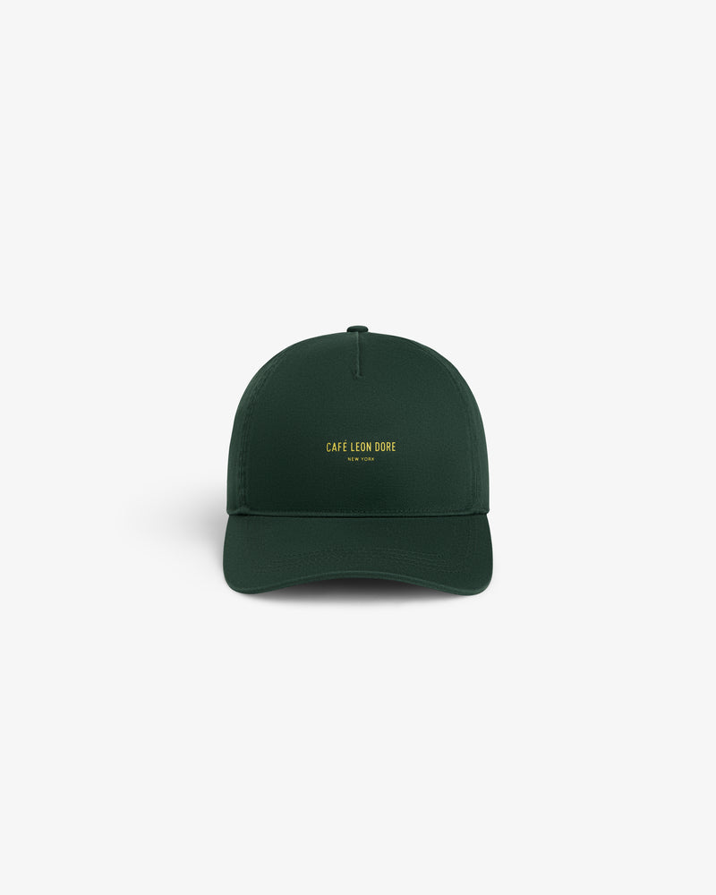 Café Leon Dore Logo Hat in dark green with yellow “CAFÉ LEON DORE NEW YORK” embroidery on the front.
