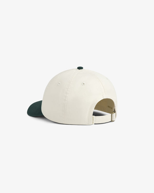 Café Leon Dore Script Hat in cream with a dark green brim, shown from the back with an adjustable strap.