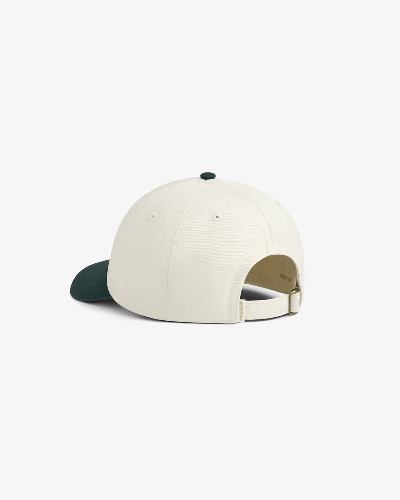 Café Leon Dore Script Hat in cream with a dark green brim, shown from the back with an adjustable strap.