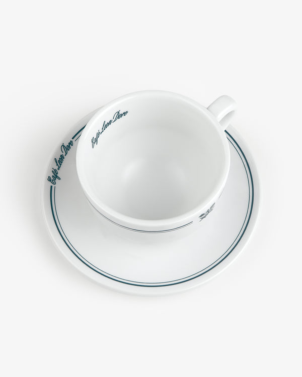 Set of 6 Café Leon Dore Cappuccino Cups & Saucers with blue trim and script, shown from above on white background.