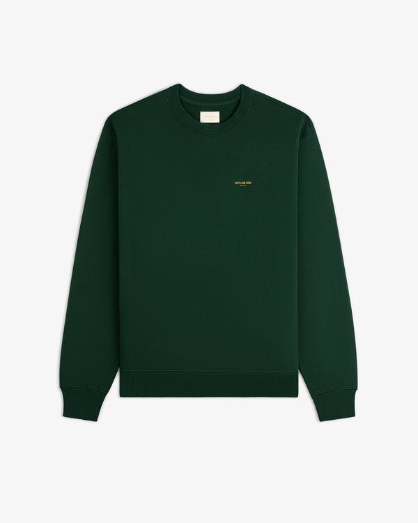 Café Leon Dore crewneck sweatshirt in dark green with small yellow left chest text, laid flat on white background.
