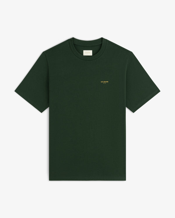 Café Leon Dore Logo Tee in dark green with small yellow chest text, shown on a plain white background.