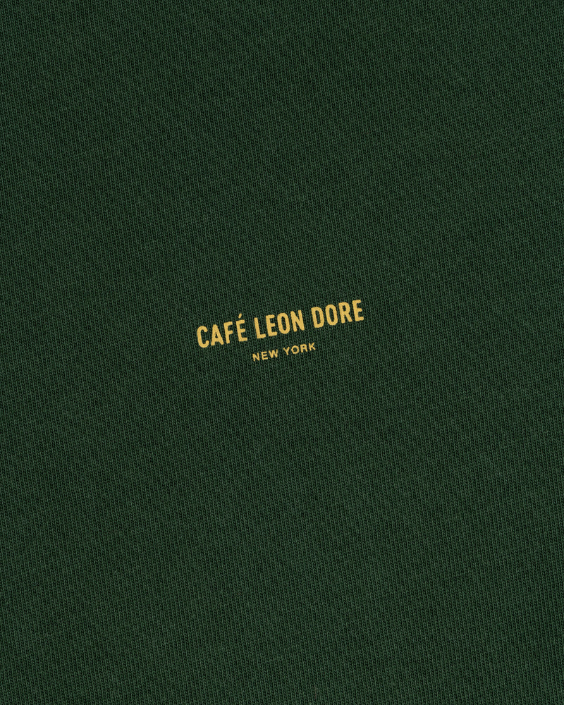 Green Café Leon Dore Logo Tee with yellow “CAFÉ LEON DORE NEW YORK” text centered on the front.