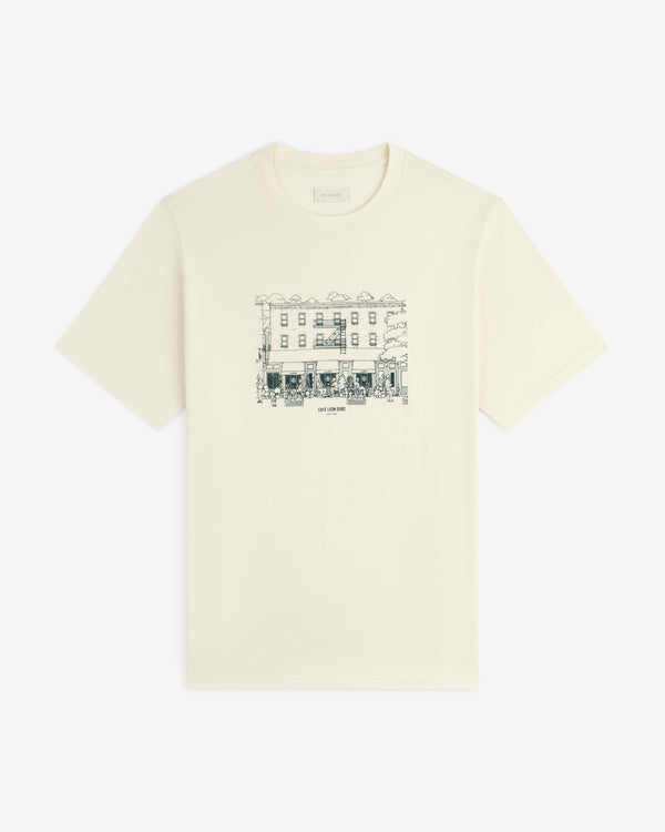 Café Leon Dore Storefront Tee: Off-white tee with black line art of a building and trees on the chest.