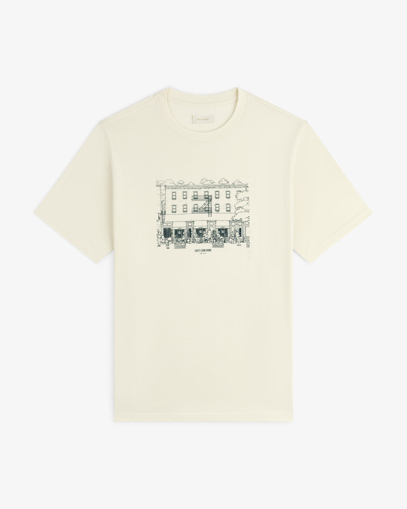 Café Leon Dore Storefront Tee: Off-white tee with black line art of a building and trees on the chest.