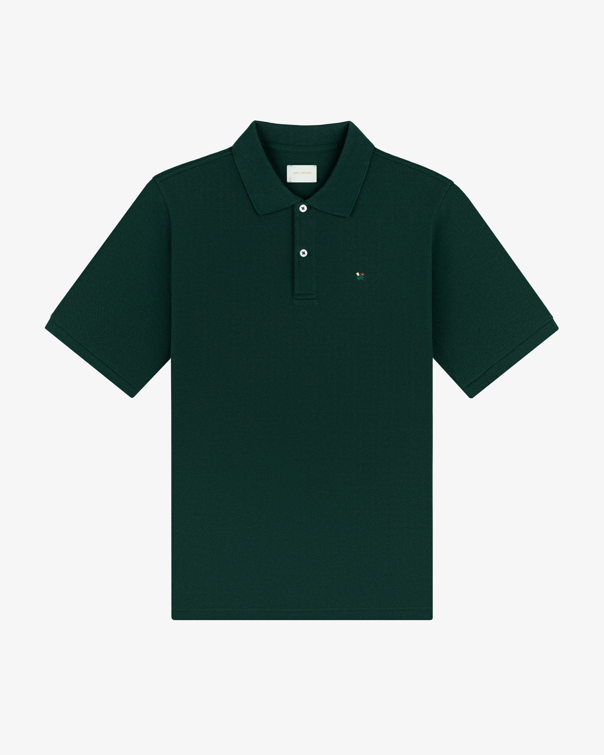 Crest Piqué Polo in dark green, short sleeves, collared with buttons, and a small chest logo, laid flat.