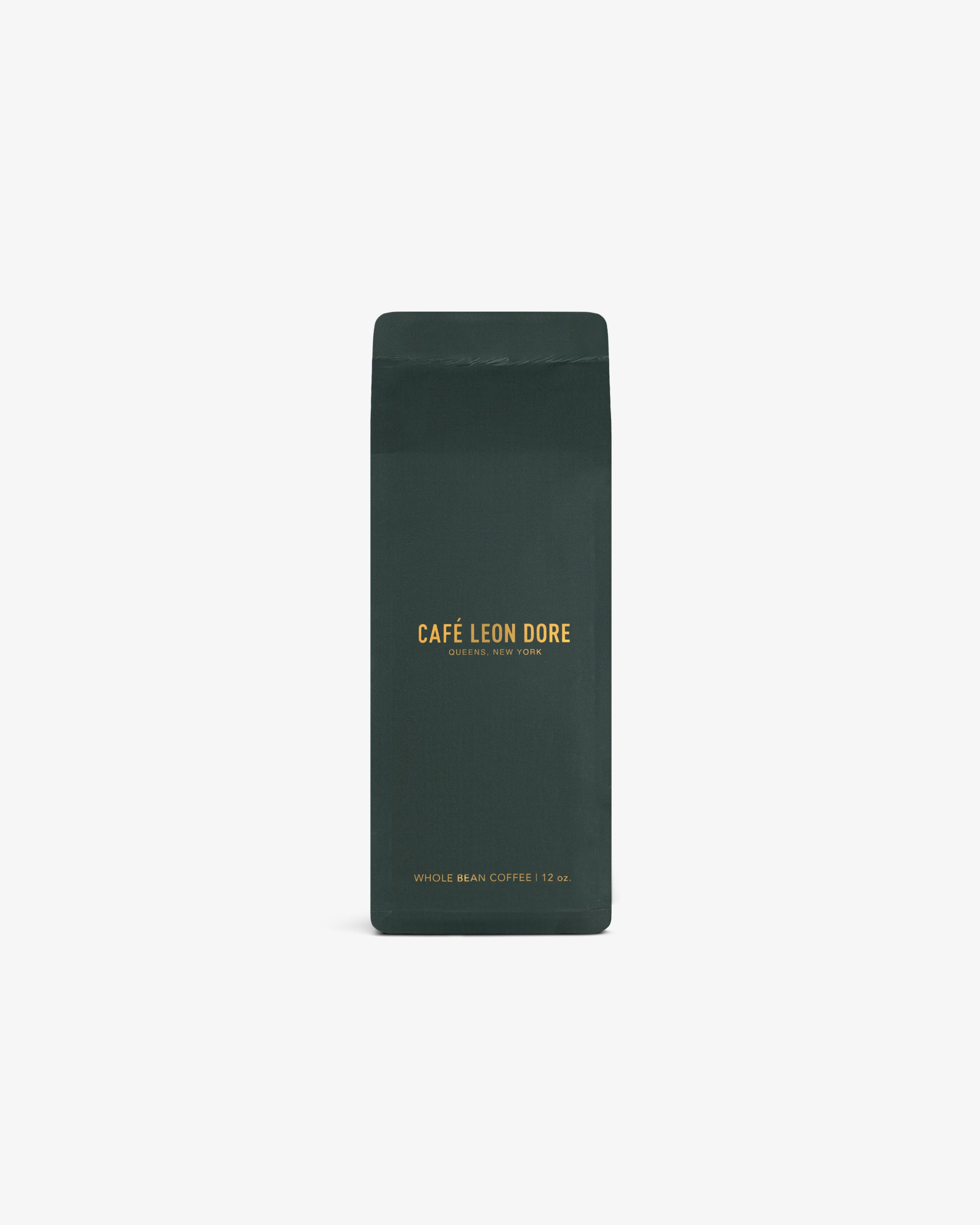Dark green bag of ALD Espresso Beans with yellow text, upright on a white background.