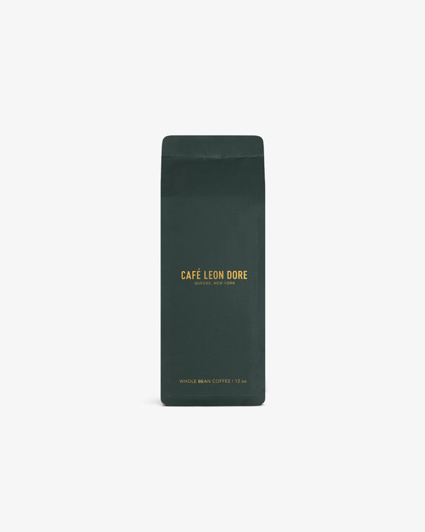Dark green bag of ALD Espresso Beans with yellow text, upright on a white background.
