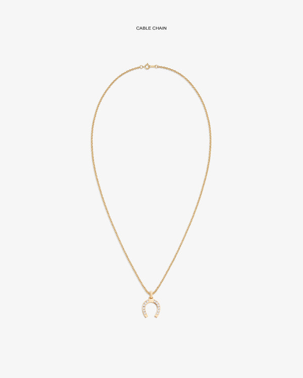 Diamond Horseshoe Pendant on gold chain, featuring small clear stones, shown against a white backdrop.