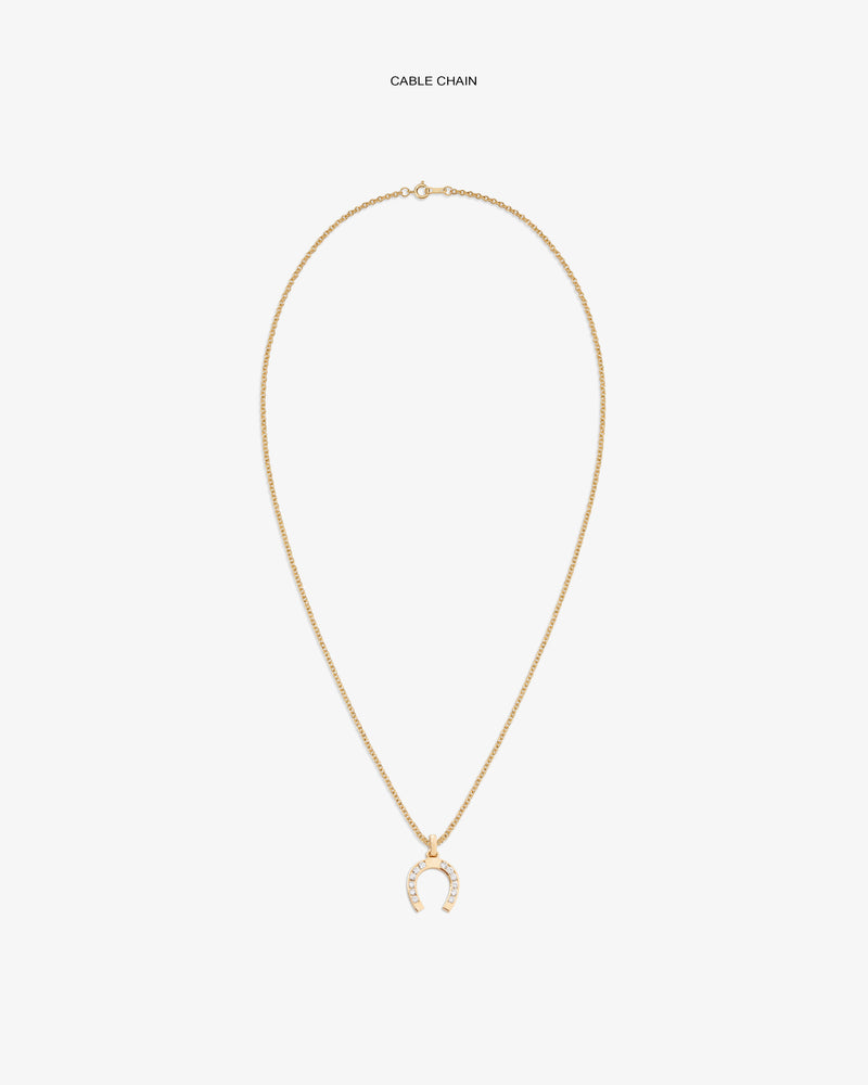 Diamond Horseshoe Pendant on gold chain, featuring small clear stones, shown against a white backdrop.