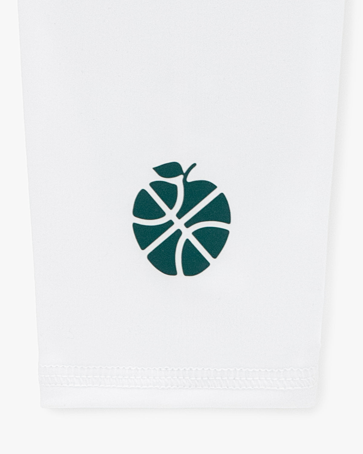 A green basketball-apple logo on white fabric features on the ALD / New Balance SONNY NY Calf Sleeves.