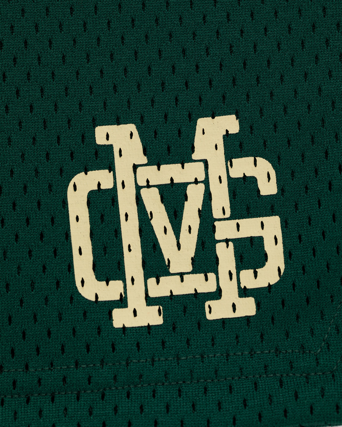ALD / New Balance SONNY NY Gym Short features a white stylized DVS logo on green mesh fabric with small holes.