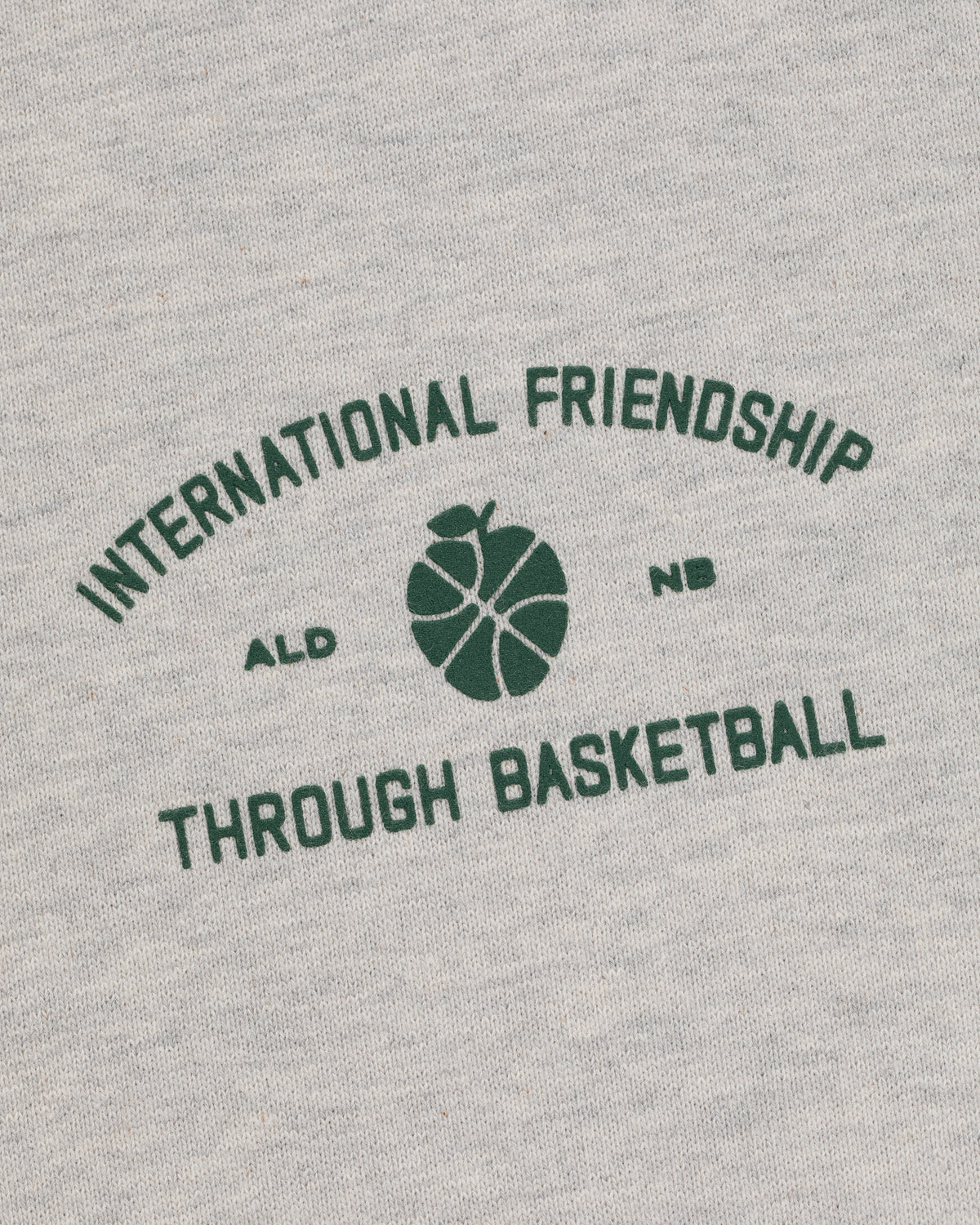 Gray ALD/New Balance SONNY NY IFTB Crewneck with green "International Friendship Through Basketball" text.