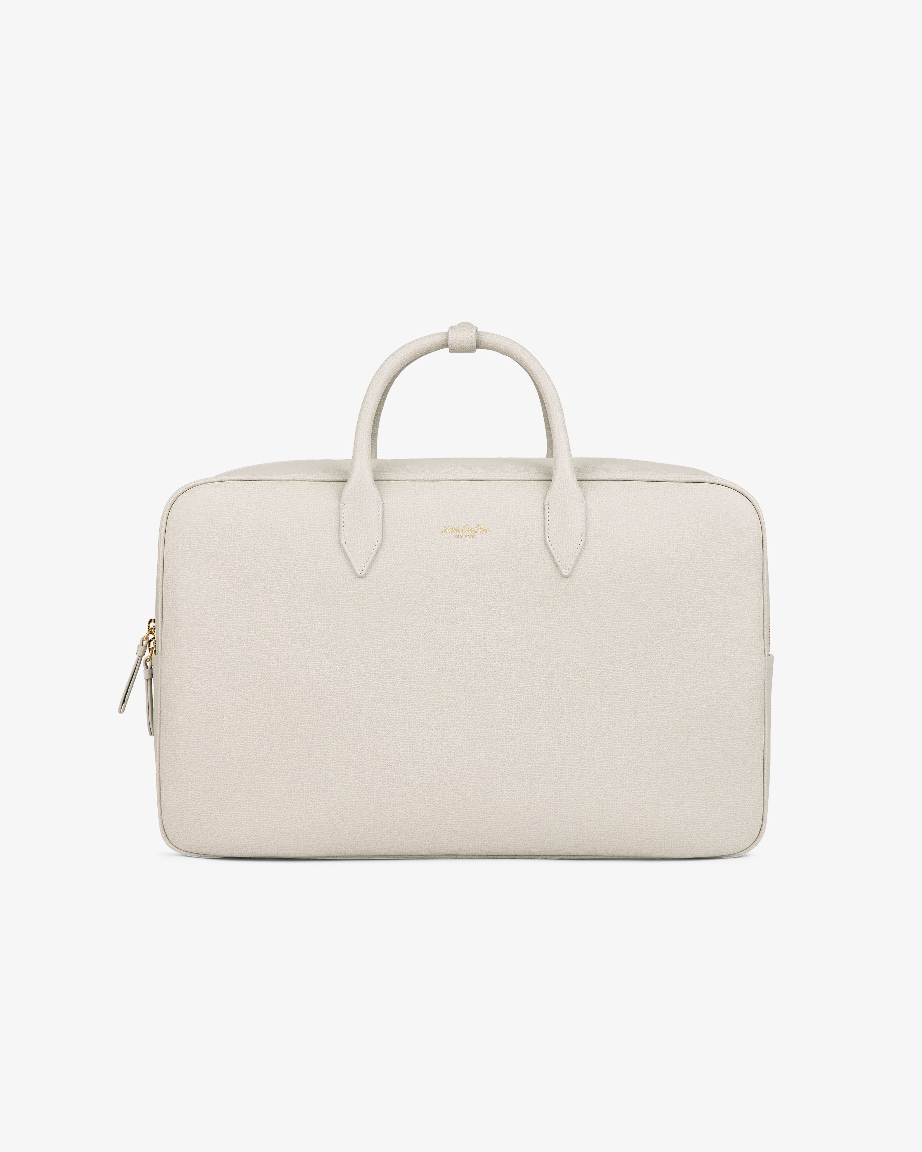 A minimalist, light beige Full Grain Leather Briefcase Duffle with two handles, zipper, and gold-tone hardware.