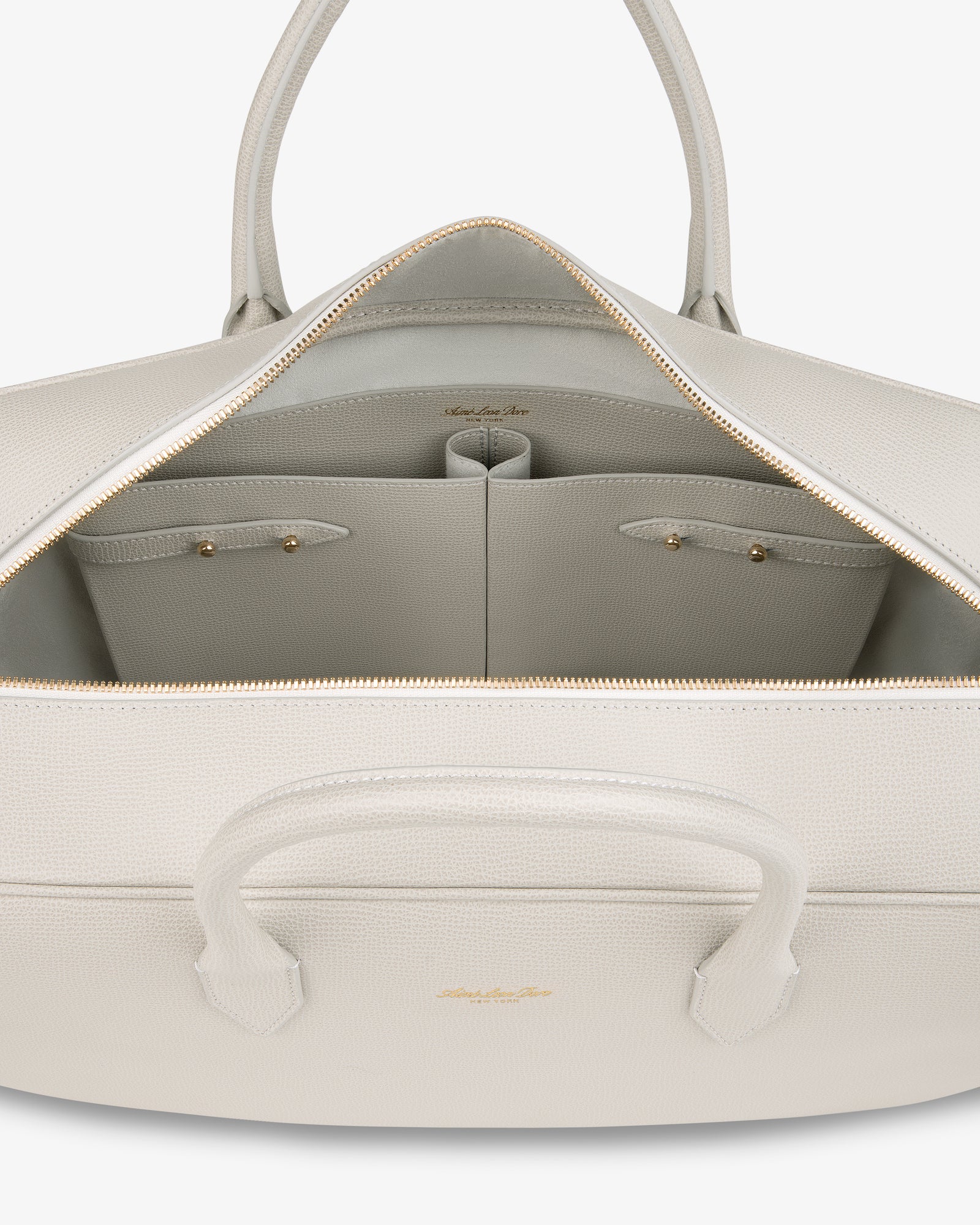 Open Full Grain Leather Briefcase Duffle showing roomy interior with two small pockets and a gold zipper.