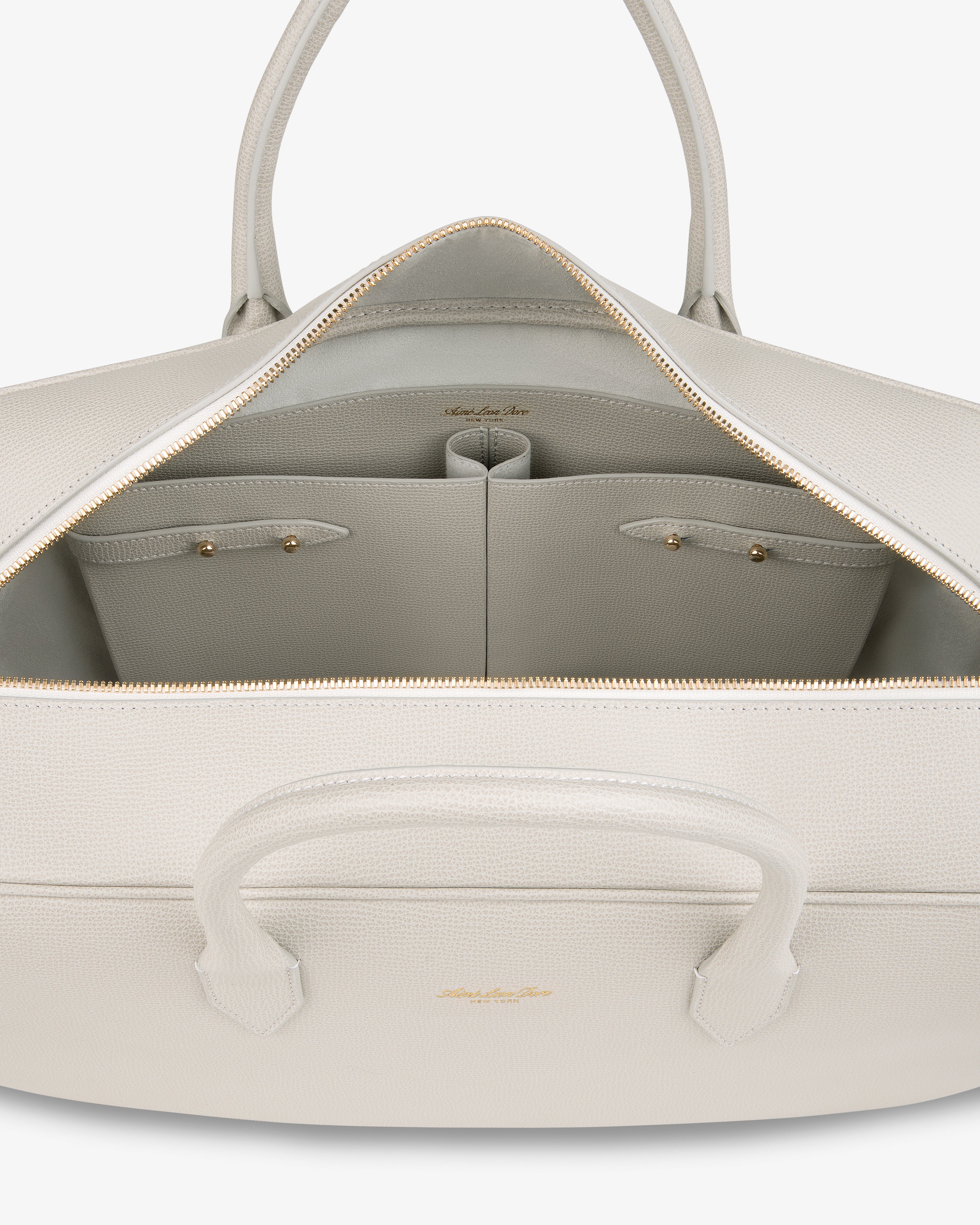 Open Full Grain Leather Briefcase Duffle showing roomy interior with two small pockets and a gold zipper.