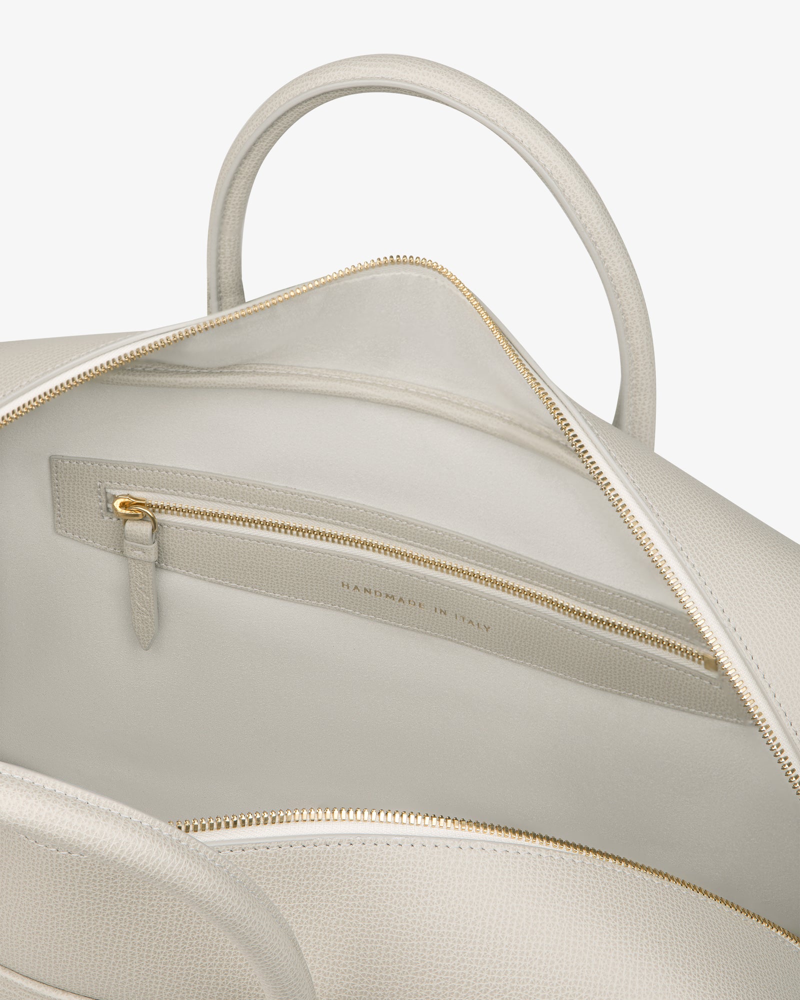 Open light beige Full Grain Leather Briefcase Duffle showing gold zipper pocket and HANDMADE IN ITALY inside.