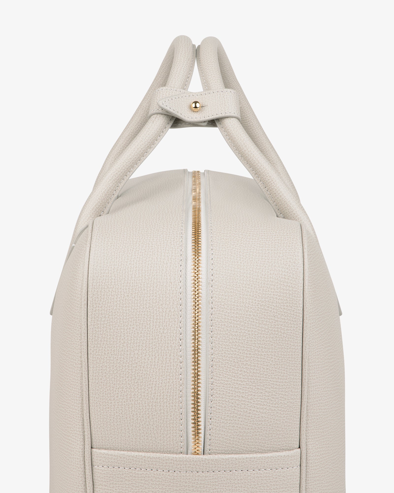 Side view of the Full Grain Leather Briefcase Duffle in light beige textured leather with gold zipper and double handles.