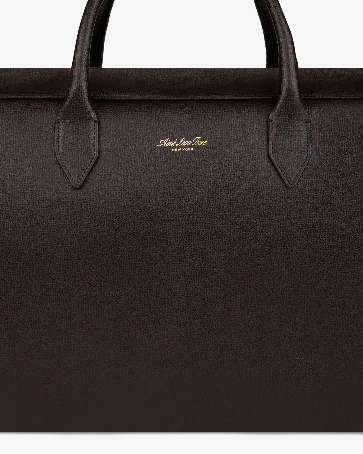 Close-up of a dark brown Full Grain Leather Briefcase Duffle with two handles and gold Mark Cross New York logo.