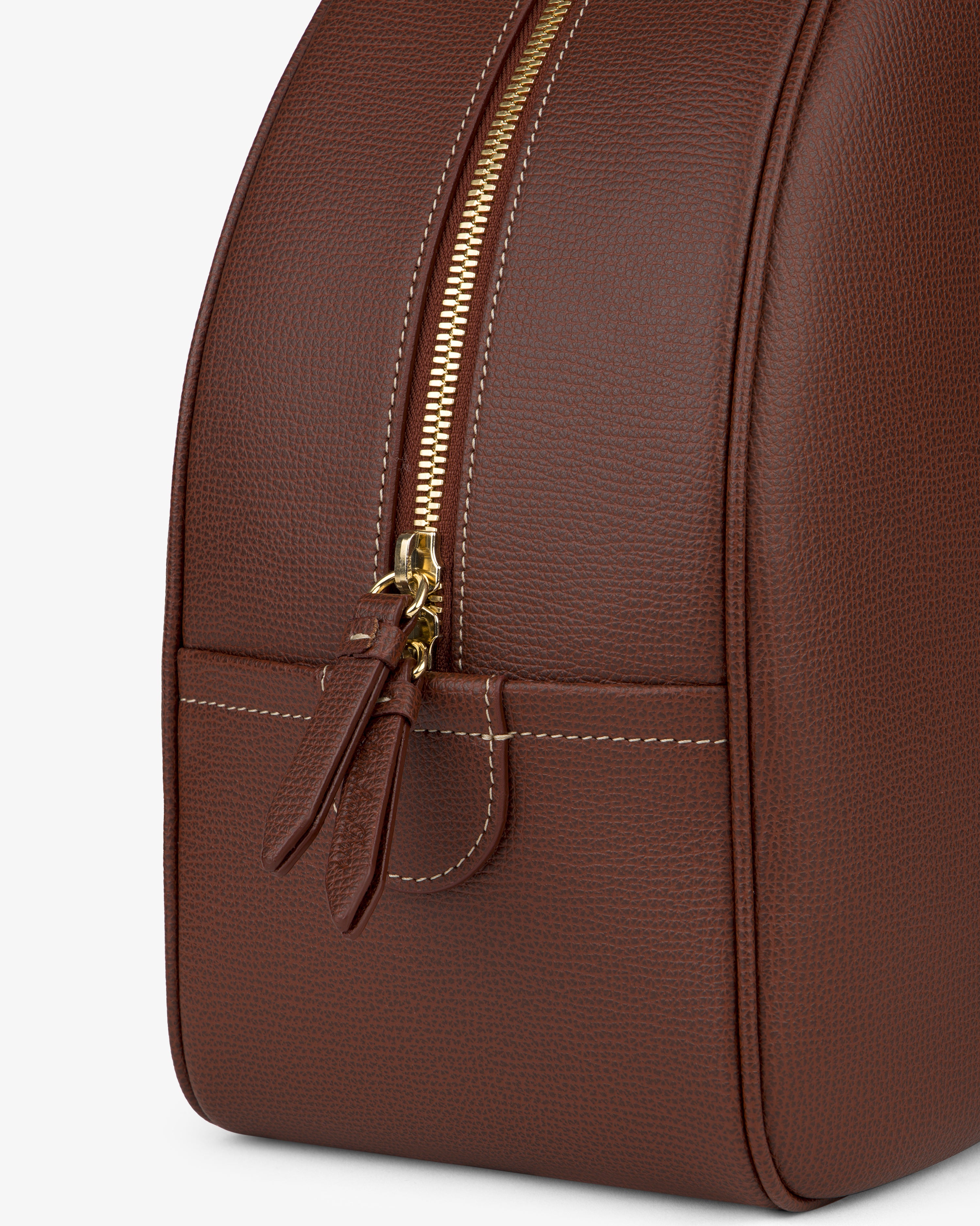 Close-up of the Full Grain Leather Crescent Shoulder Bag with gold zipper, white stitching, dual pulls, and front pocket.