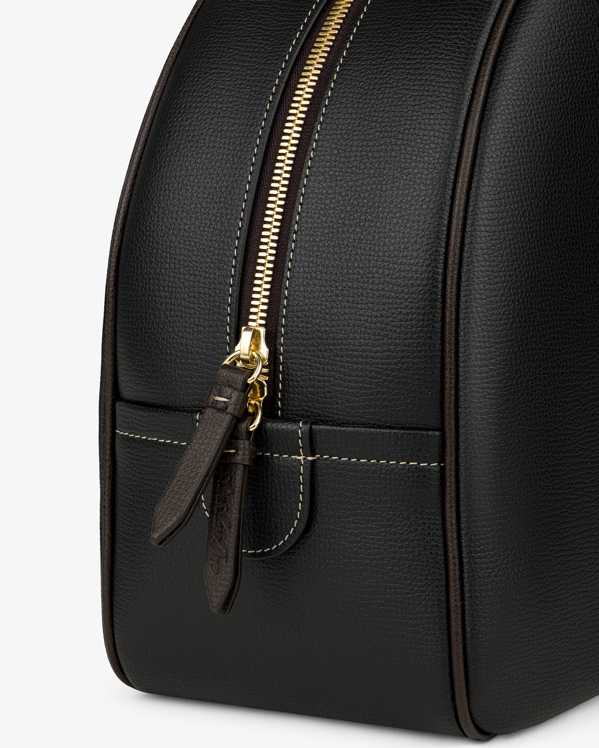 Close-up of the Full Grain Leather Crescent Shoulder Bag in black with gold zipper, brown pull tabs, and white stitching.