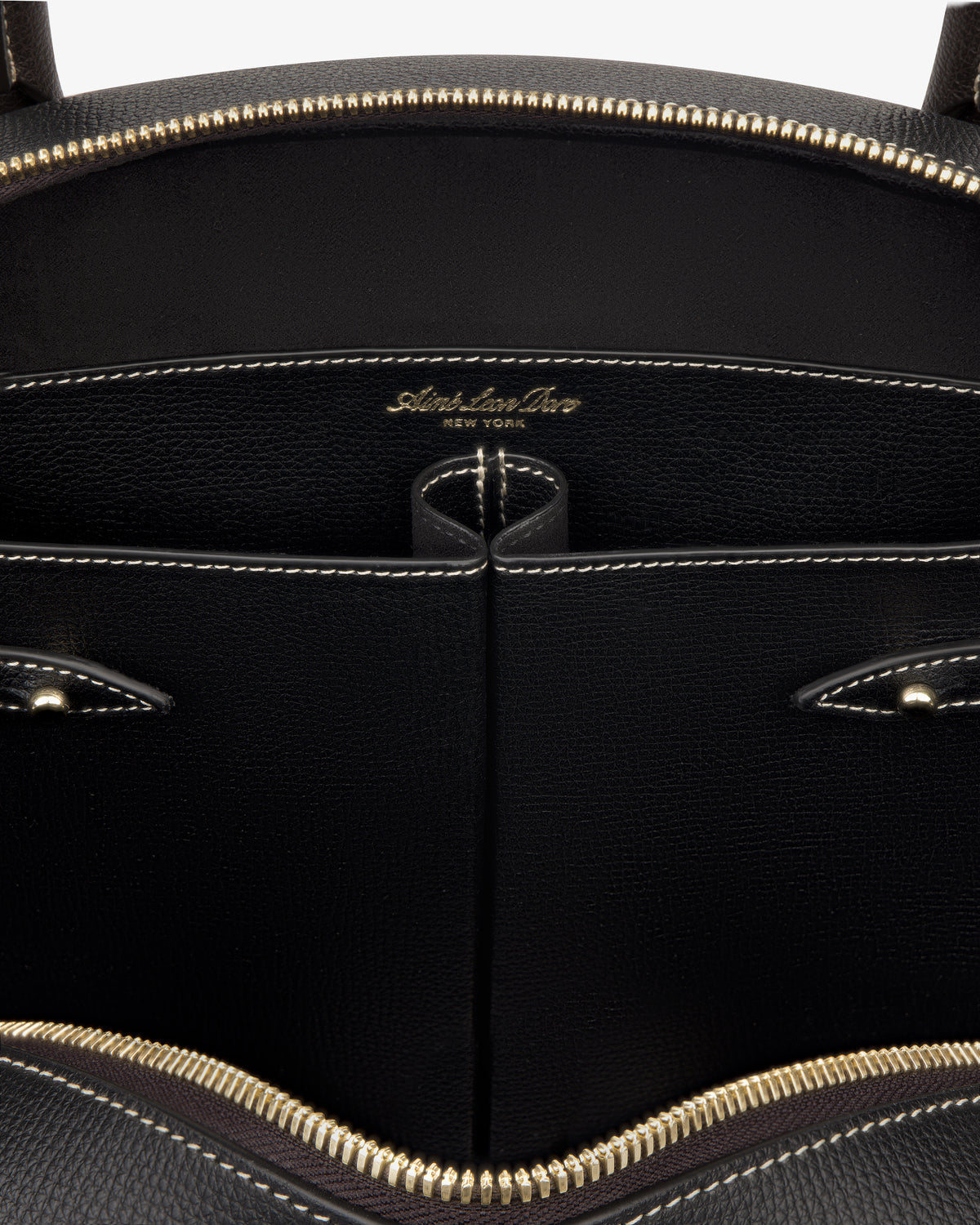 Close-up of the Full Grain Leather Crescent Shoulder Bag’s black interior with gold zipper and Sabrina Zeng New York label.