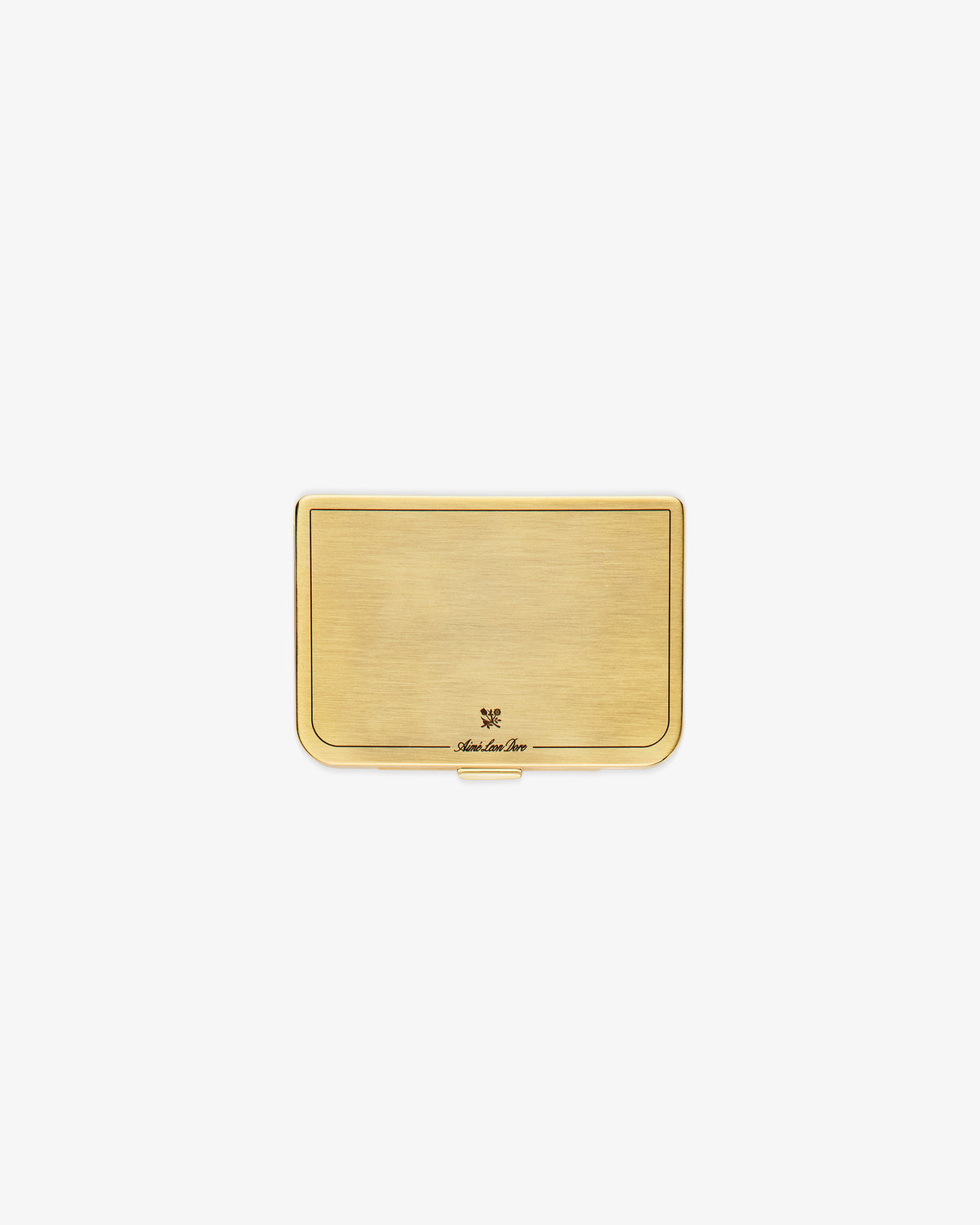 The Brass Card Case is a rectangular gold metal holder with a brushed finish and a small engraved logo at the bottom.