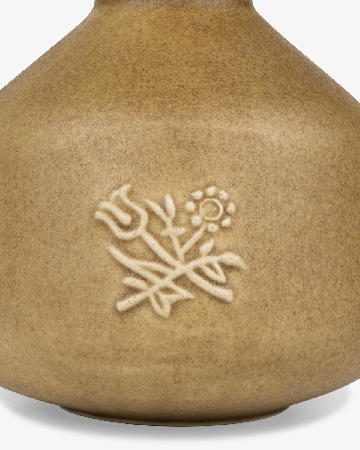 The Queens Crest Artisanal Bud Vase is a brown ceramic vase with embossed flowers and leaves on its surface.