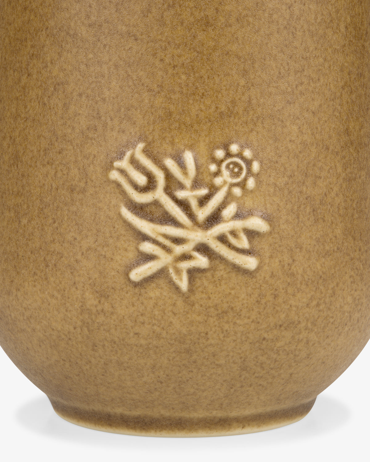 Close-up of the Queens Crest Artisanal Vase, featuring embossed tulip and daisy designs on brown ceramic.