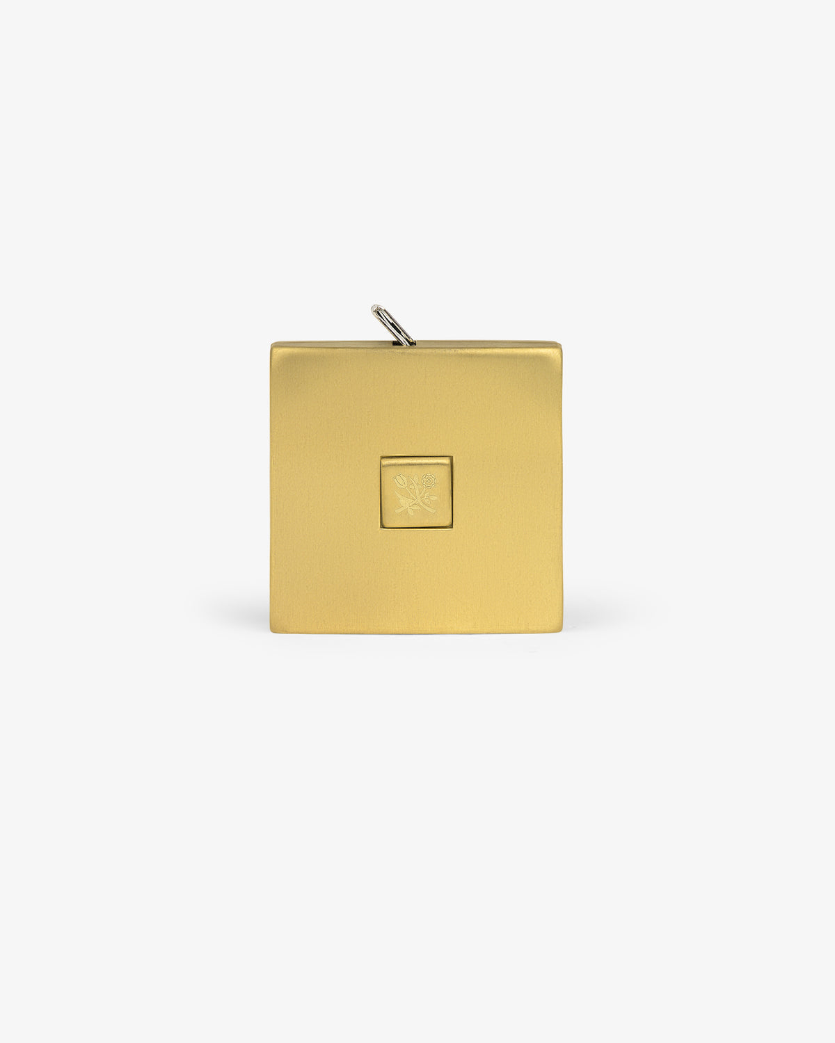 The Queens Crest Brass Tape Measure is square with an embossed center design and a loop at the top for a chain.