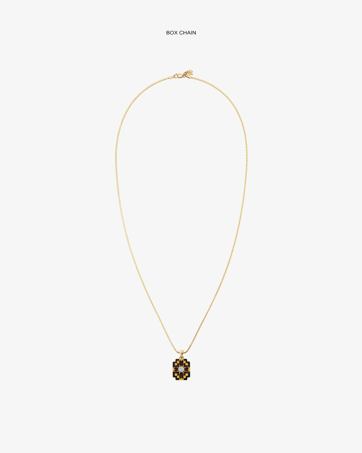 Diamond Mosaic Pendant: Gold box chain necklace with a small square pendant featuring a black and gold geometric design.