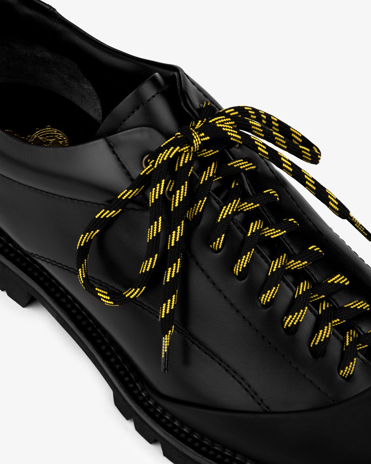 Leather Derby Hiker with black and yellow striped laces, angled top view on a white background.