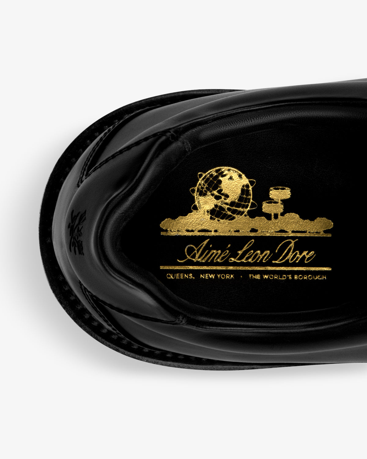 Top view of Leather Derby Hiker insole: black with gold Aimé Leon Dore, globe, clouds, and Queens, New York text.